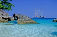 star clipper sails down water view