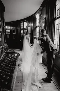 Modern wedding photography at Royal College of Physicians Edinburgh featuring the happy couple just married and sorting out the brides veil
