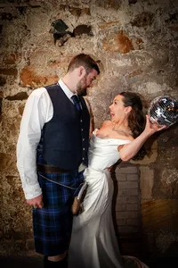 Modern wedding photography at Kinkell Byre and wedding couple having fun with disco balls in the evening