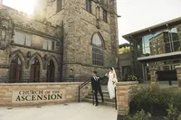 Hannah and Shea outside the stone Church of the Ascension in Pittsburgh on their wedding day