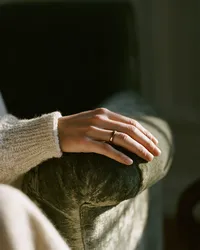 krista5123_Womans_hand_resting_along_the_worn_arm_of_a_mushro_f6947845-8ea6-48a8-9b5f-3b761a19fcb8_2