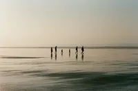 krista5123_Family_crossing_a_wide_expanse_of_wet_sand_at_low__6677d205-6e51-48ee-8449-5e84ff90175c_0