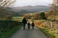krista5123_A_family_walking_together_along_a_quiet_country_ro_426591f9-8962-4ac3-a22b-665b28deefc9_1