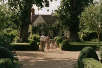 krista5123_Family_crossing_a_gravel_courtyard_toward_an_inher_c7d10931-a3c8-43f9-abdf-c874cc09b263_2
