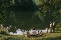 krista5123_Family_gathered_on_the_bank_of_a_still_lake_some_s_c6c5e271-b2b2-4691-9518-3cb6bd7488da_0