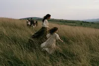 krista5123_A_mother_and_daughter_walking_through_waist-high_g_c97f6668-8053-46d4-8ee4-9e5fe80b3fcb_0