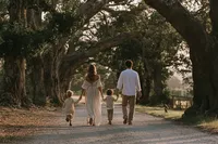 krista5123_Parents_and_three_children_walking_beneath_an_aven_1c38ccea-97ee-4dcc-acf0-cdb103386fc8_2