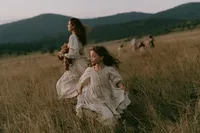 krista5123_A_mother_and_daughter_walking_through_waist-high_g_c97f6668-8053-46d4-8ee4-9e5fe80b3fcb_2