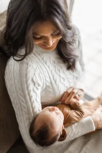 Parent holding newborn baby Kai during a lifestyle newborn session
