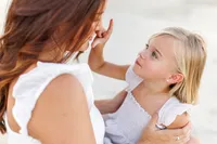 Mother holding baby close during a Palm Springs lifestyle photography session