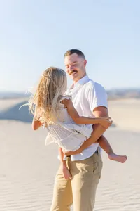 Father and daughter dancing in the dunes of Palm Springs