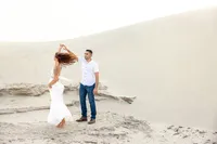 Couple posed together on the sand dunes during a Palm Springs photography session