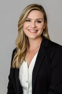 Woman in professional attire posed for a Sherwood Partners corporate headshot