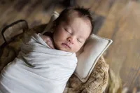 Newborn baby Kai sleeping during a lifestyle newborn photography session