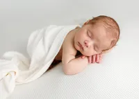 Newborn baby wrapped and posed in a La Quinta photography studio