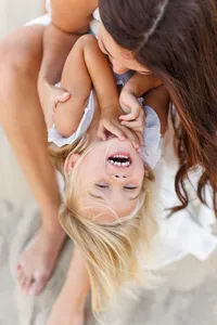 Mother kissing baby's forehead during a Palm Springs portrait session