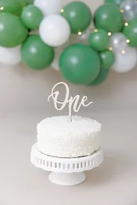 Baby with cake smash setup during a La Quinta studio first birthday session