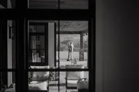 A father holds his daughter through the window during an at home family photo session in houston texas