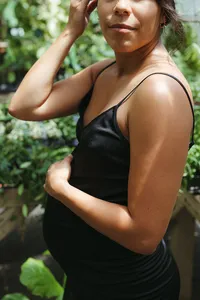 A mother holds her pregnant belly during her maternity photos in houston texas
