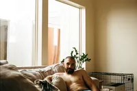A husband glances at the window trying not to smile for a photo in conroe texas