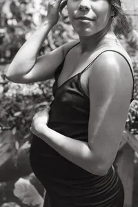 A mother holds her pregnant belly during a Houston Texas Maternity photo session