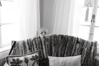 A boy peeks over a couch during an at home family session in Houston Texas