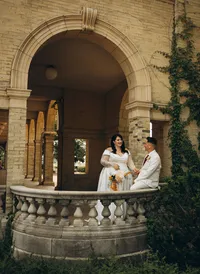 Michigan elopement photographer Grace Wan captures a bride and groom standing on an ornate balcony on their elopement day.