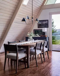 Mid-century modern A-frame dining space interior design with warm wood tones and metal details.