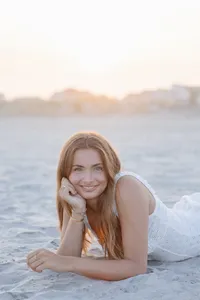Woman's branding portrait lying on the beach at sunset