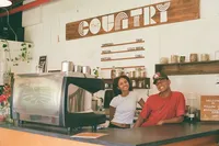 Friendly baristas smiling at the counter at The Country Eatery on Oahu