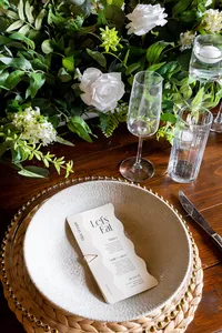 wedding table setting with place setting and white rose florals