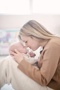 Mother nuzzling her newborn baby