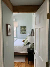 View through the doorway into the primary bedroom at Brookside Retreat