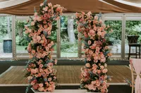 pink floral ceremony arch at The Woodman Inn