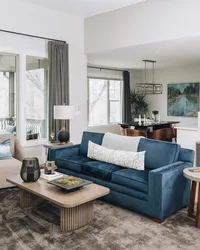 Blue velvet couch and cool tones in a traditional living room designed by Asheville interior designer Jennifer Smith Design.