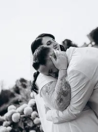 Black and white elopement photography of a bride and groom hugging during their first look together.