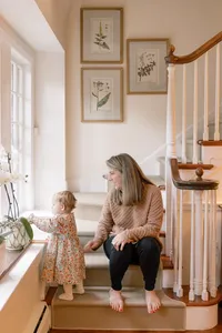 Mother and toddler sitting together on an indoor staircase
