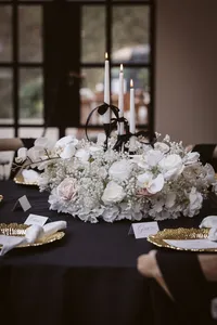 black wedding decor with white floral table centrepieces