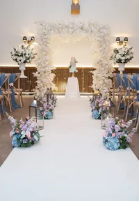 Loretta styling collectio pastel floral display down the aisle and large square white floral ceremony arch