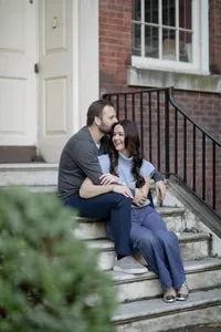 Couple embracing sitting on brick steps during their engagement session