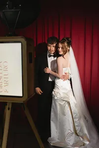 wedding-photo-booth-red-curtain-couple