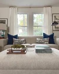 Living room design details on a styled, patterned ottoman.