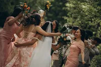 Grand Rapids wedding photographer Grace Wan captures a bride with her back to the camera surrounded by all her bridesmaids celebrating.