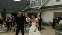 Wedding videography still of bride and groom celebrating at luxury house wedding venue