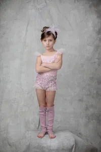 Girl in a pink sequined outfit with arms crossed during her studio portrait session