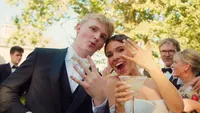 Wedding videography still of bride and groom displaying their wedding rings to brooke and david