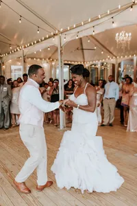 Newlyweds dance underneath a white A-frame tented deck at Chesapeake Bay Foundation Weddings and Events