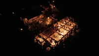 Wedding videography still of luxury evening reception space with warm candlelight and ambient lighting
