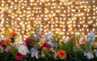 colourful floral arrangement with fairy light backdrop