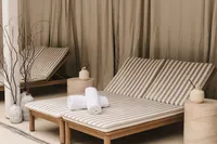 processed_Bathhouse - Minimalist bedroom with striped bedding and wooden furniture - TVS